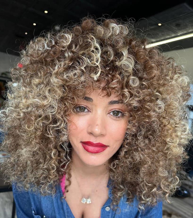 18. Bright blonde balayage with playful curls