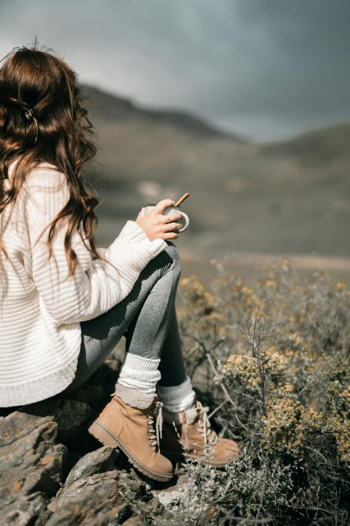 Cozy layers and neutral boots for a serene outdoor look